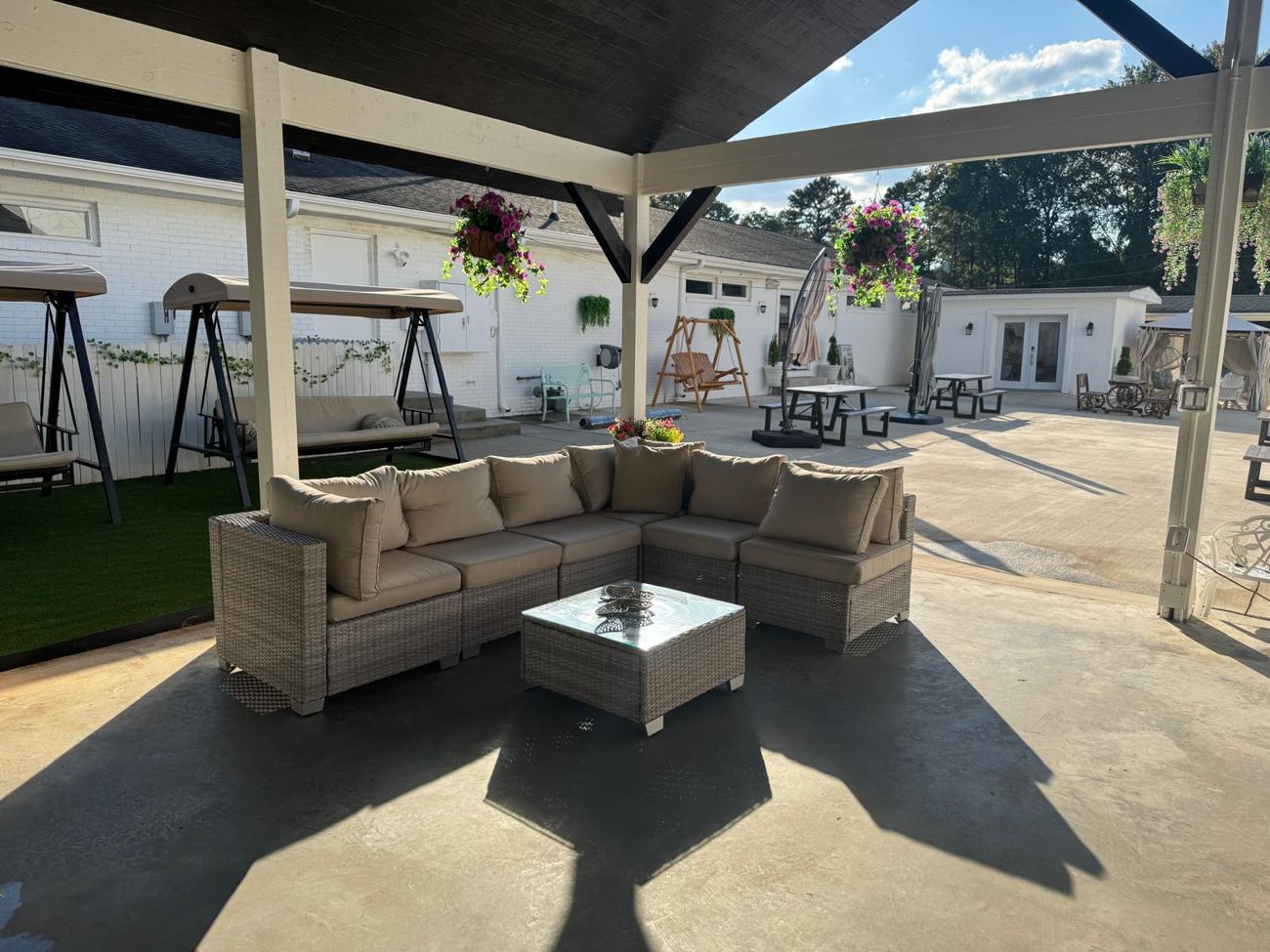 Pavilion with wicker sofas and swings